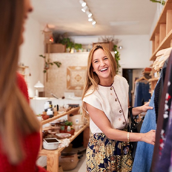 Woman smiling while shopping with friend in store