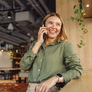 Woman smiling while talking on phone