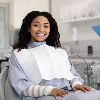 Woman smiling while sitting in treatment chair