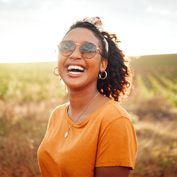 A smiling woman with sunglasses on