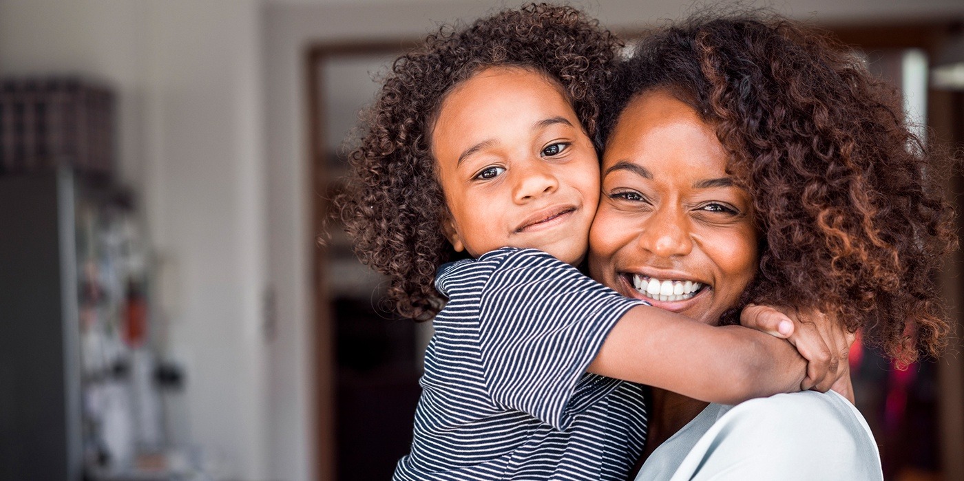 woman hugging her young child