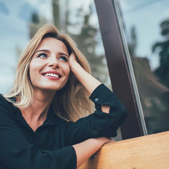 woman smiling with dental bridges in Weatherford