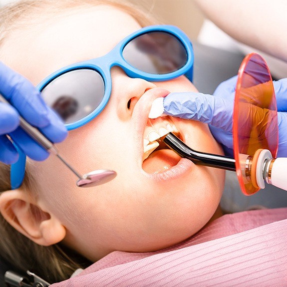 Child receiving dental sealants