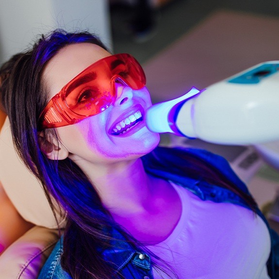 Woman receiving teeth whitening treatment
