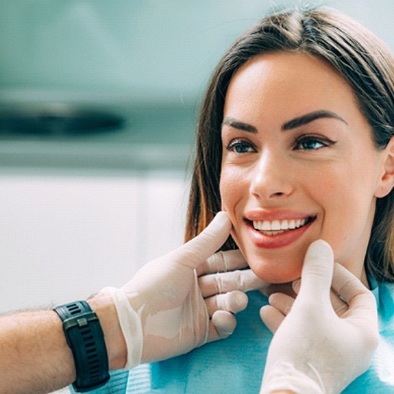 patient smiling after getting cosmetic dentistry