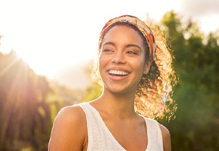 woman smiling while standing outside