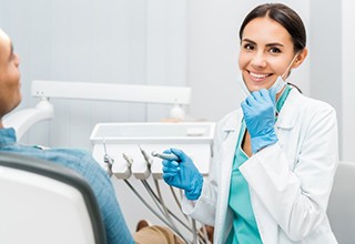 female dentist smiling toward camera 