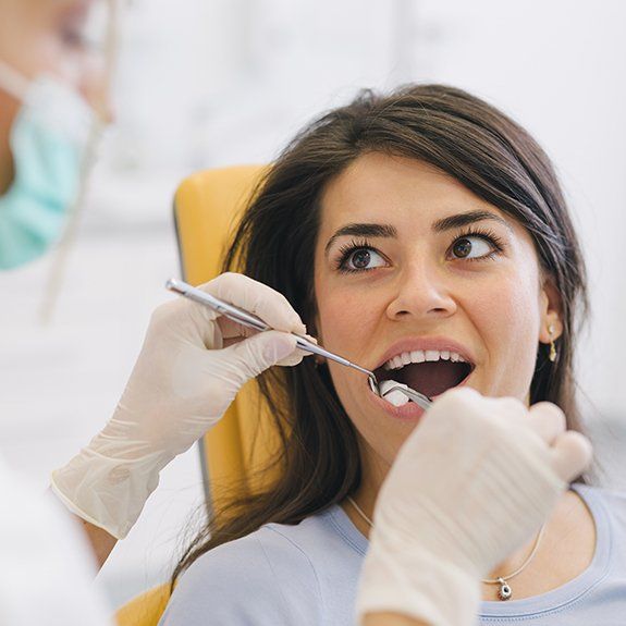 Woman receiving tooth extraction