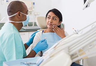 Dentist and patient having a serious conversation