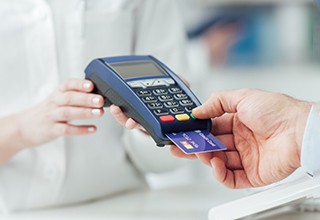 Dental patient using card to pay for treatment