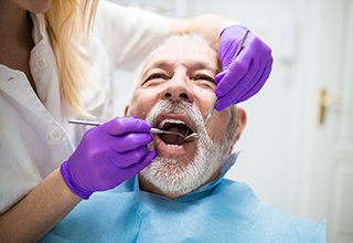 Implant dentist in Weatherford performing a dental exam