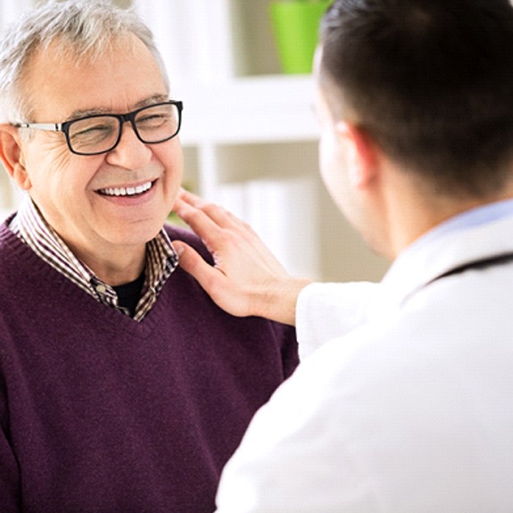 Weatherford implant dentist and patient discussing implant dentures