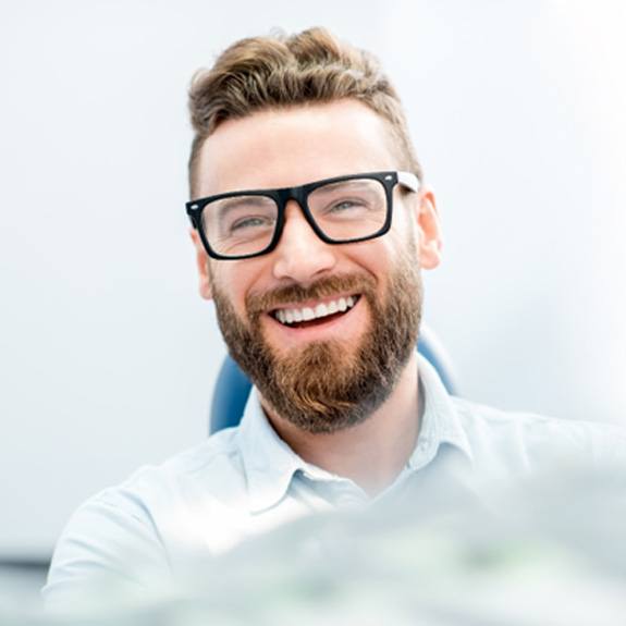 man smiling after getting dental implants 