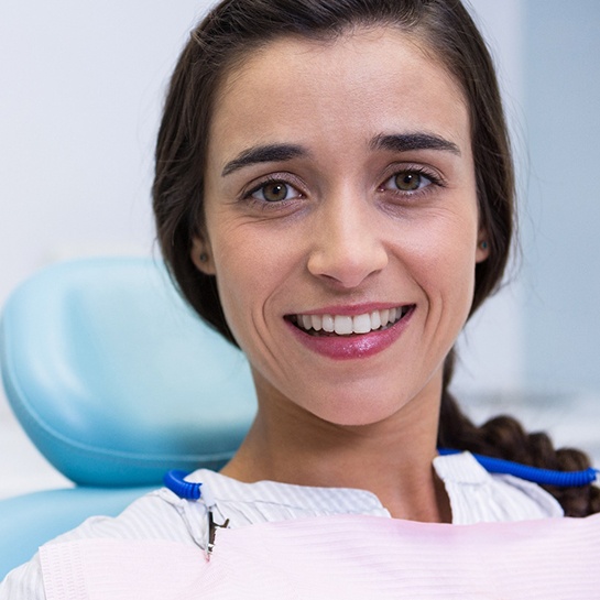 Woman smiling after getting dental implants in Weatherford, TX