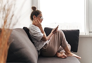 Woman resting at home after getting dental implants in Weatherford, TX