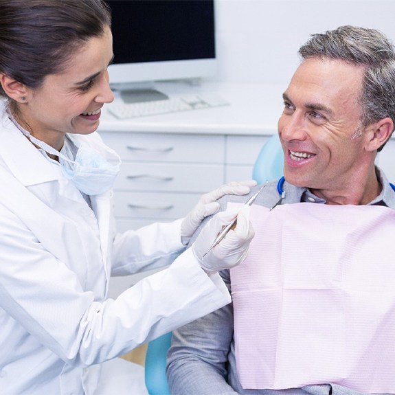 Older man completing consultation for dental implants in Weatherford