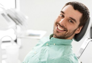 Man leaning back in dental chair with dental implants in Weatherford, TX
