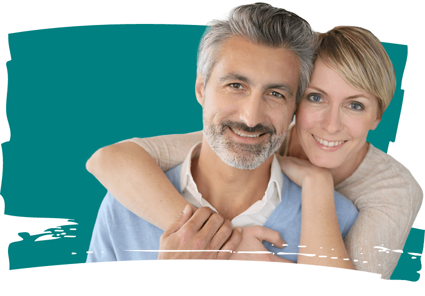Smiling man and woman in front of teal background