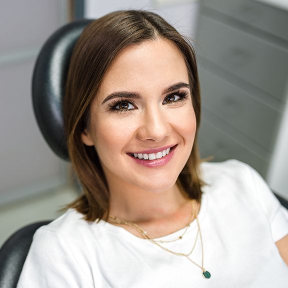 Woman in dental chair smiling