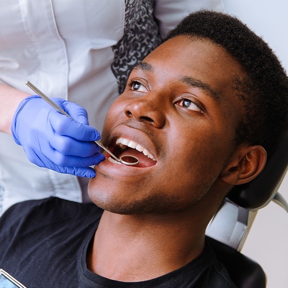 Patient receiving oral cancer screening