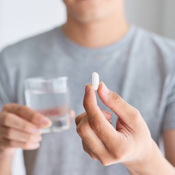 Man holding an oral conscious sedation dentistry pill