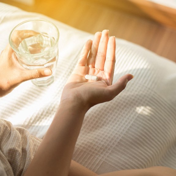 Woman holding a pill