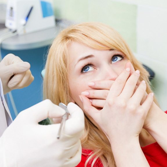 Woman nervous in the dental chair