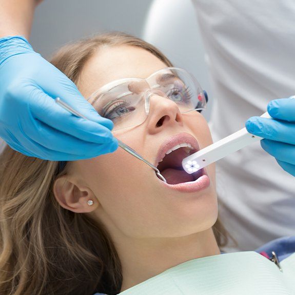 Dentist using intraoral camera to capture images of patient's smile