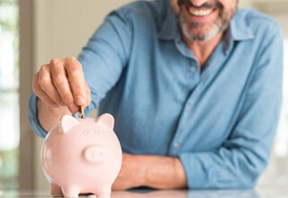 a person putting money into a piggy bank