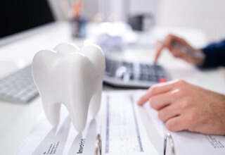 a patient filling out a dental insurance form