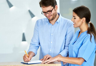 a patient discussing finances with his dentist