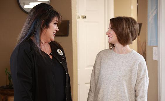 Dental team member smiling with dental patient in Weatherford