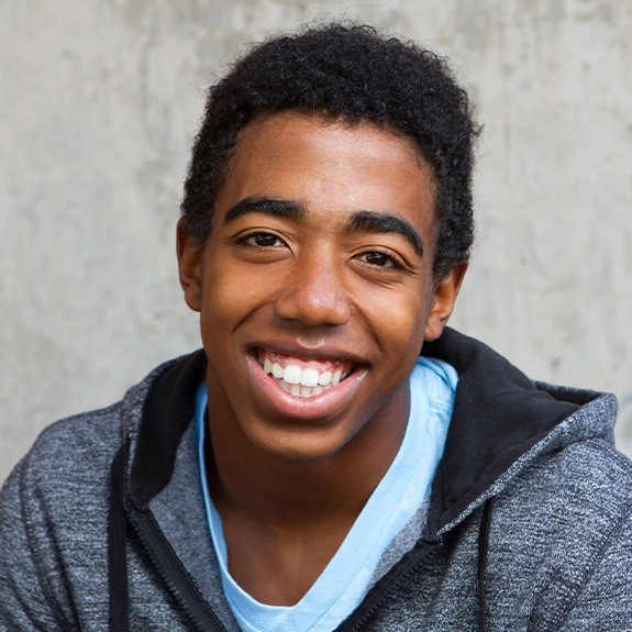 Young man smiling after wisdom tooth extraction