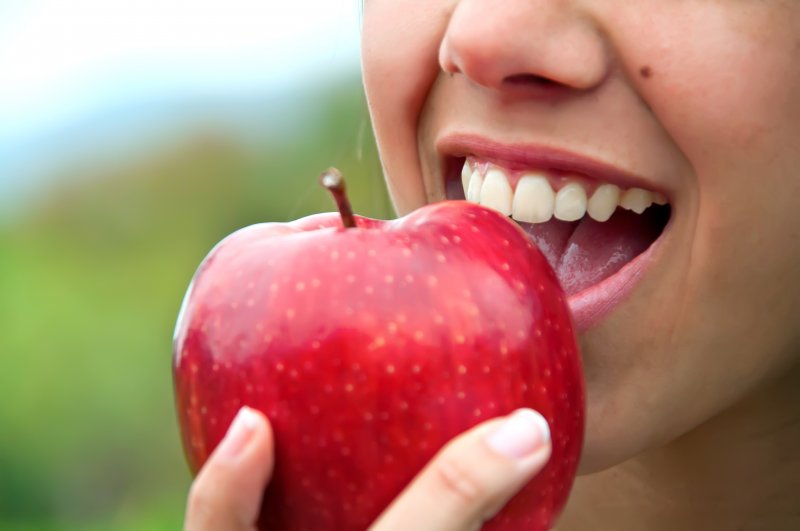 Person biting apple