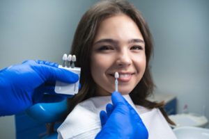 A patient smiling and receiving cosmetic dental work.