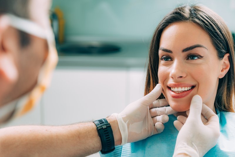 A cosmetic dentist assessing his female patient