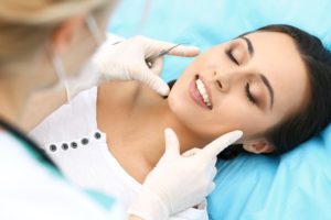 Dentist examining a woman’s smile