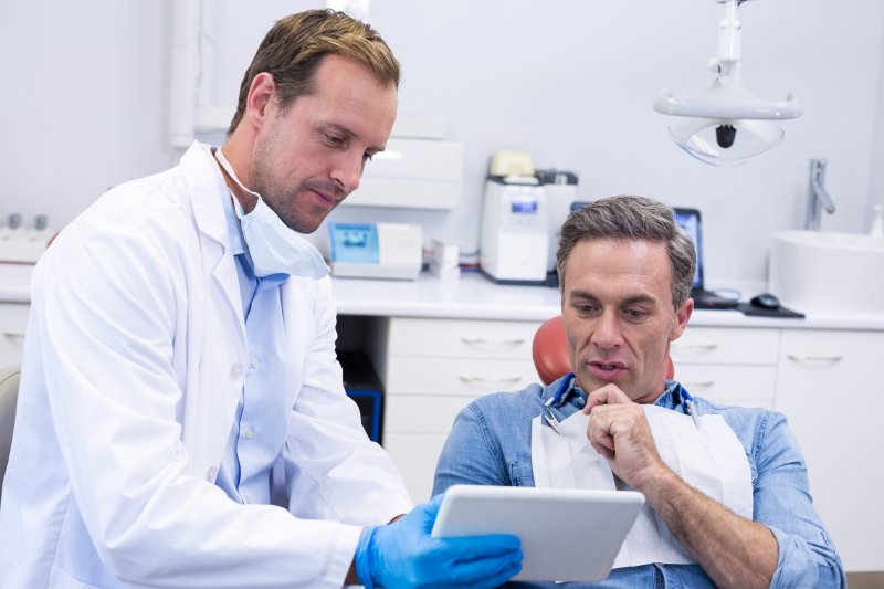 A patient consulting his dentist about gum disease treatment