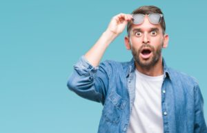 Man shocked and raising his glasses